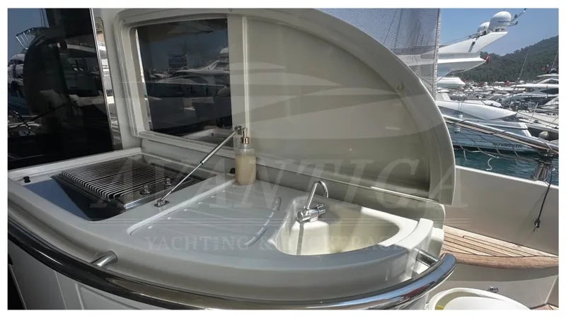  Yacht Photos Pics Outdoor kitchen area on a 2009 Azimut 68S yacht, featuring a sink and grill.