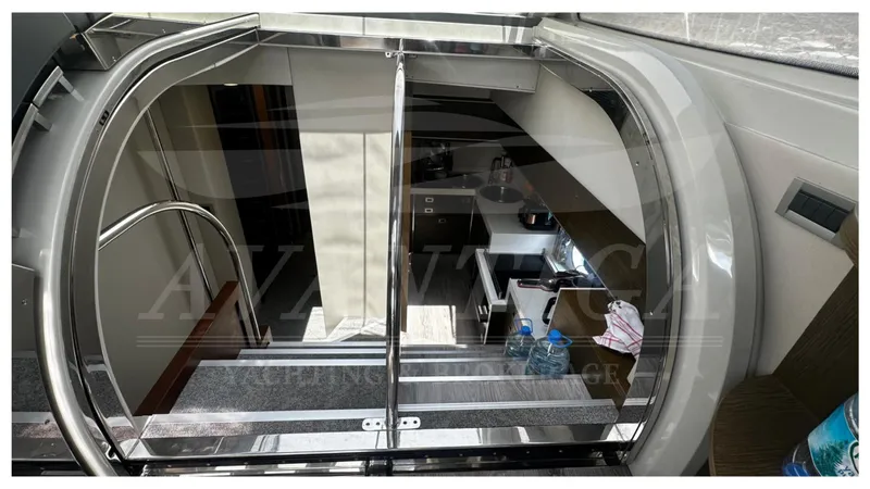  Yacht Photos Pics Interior view of 2009 Azimut 68S yacht, featuring a modern staircase and kitchenette.