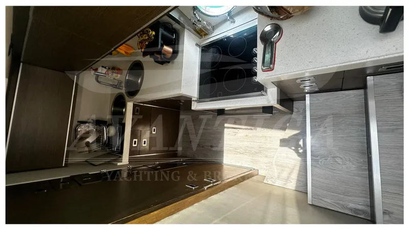  Yacht Photos Pics Modern kitchen interior of 2009 Azimut 68S yacht with sleek appliances and cabinetry.