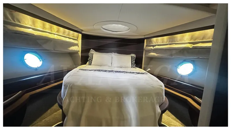  Yacht Photos Pics Luxurious bedroom interior of 2009 Azimut 68S yacht with porthole windows.