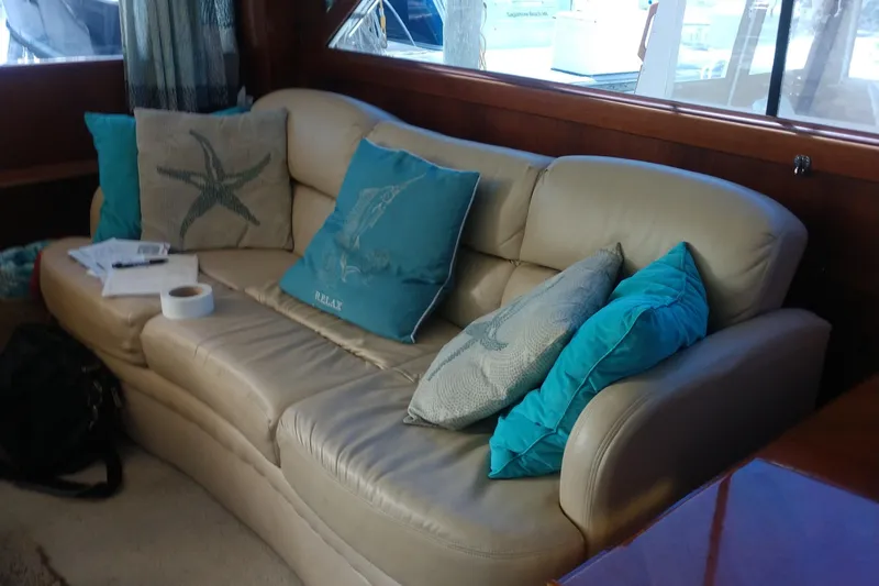  Yacht Photos Pics Luxurious interior of 1989 Ocean Yachts 44 Super Sport with beige leather sofa and teal cushions.