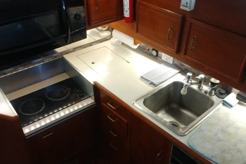  Yacht Photos Pics Galley kitchen in 1989 Ocean Yachts 44 Super Sport Custom with stove and sink.