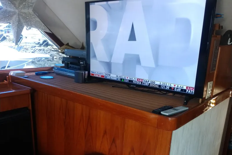  Yacht Photos Pics 1989 Ocean Yachts 44 Super Sport Custom interior with TV and wooden cabinetry.