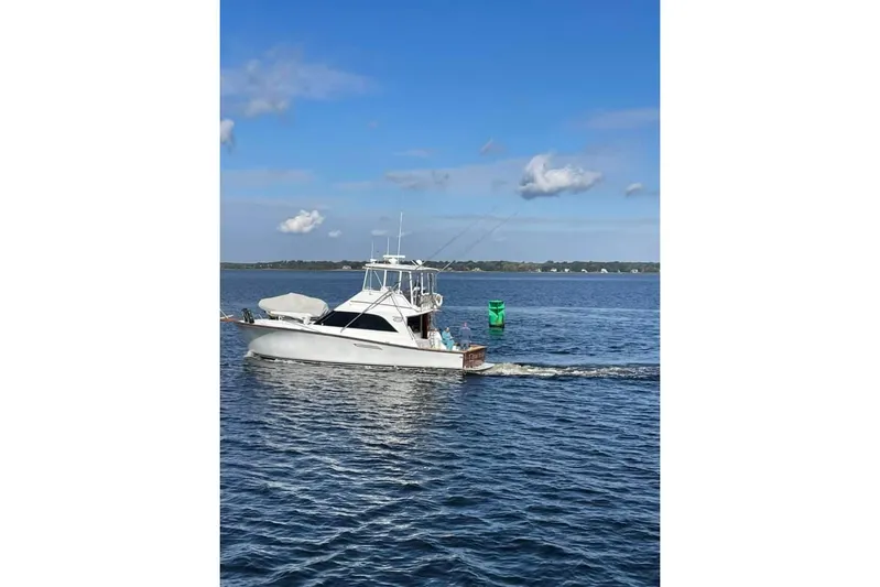  Yacht Photos Pics 1989 Ocean Yachts 44 Super Sport Custom cruising on a calm blue sea.