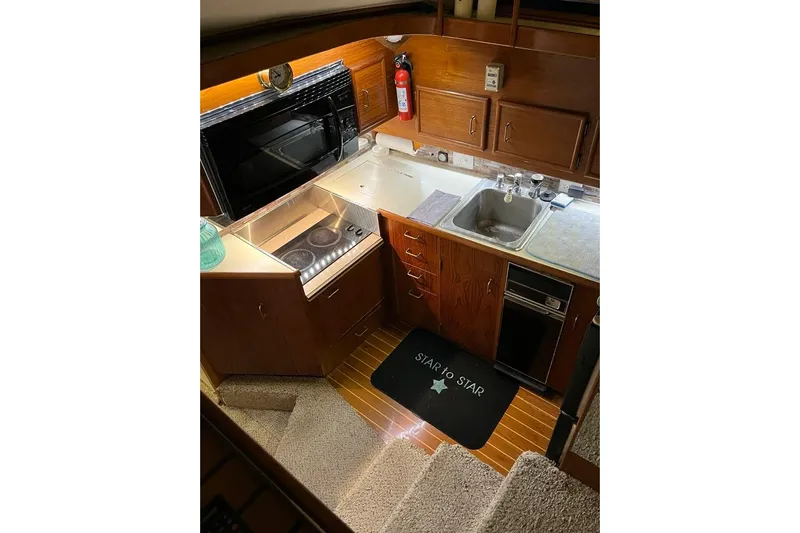  Yacht Photos Pics 1989 Ocean Yachts 44 Super Sport Custom galley with stove, sink, and wooden cabinetry.