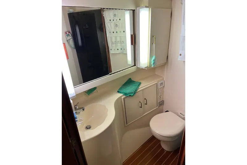  Yacht Photos Pics Bathroom interior of 1989 Ocean Yachts 44 Super Sport Custom, featuring sink and toilet.