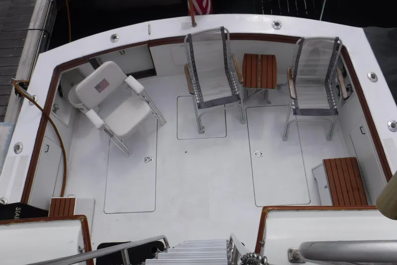  Yacht Photos Pics 1989 Ocean Yachts 44 Super Sport Custom deck with chairs and tables, docked at marina.