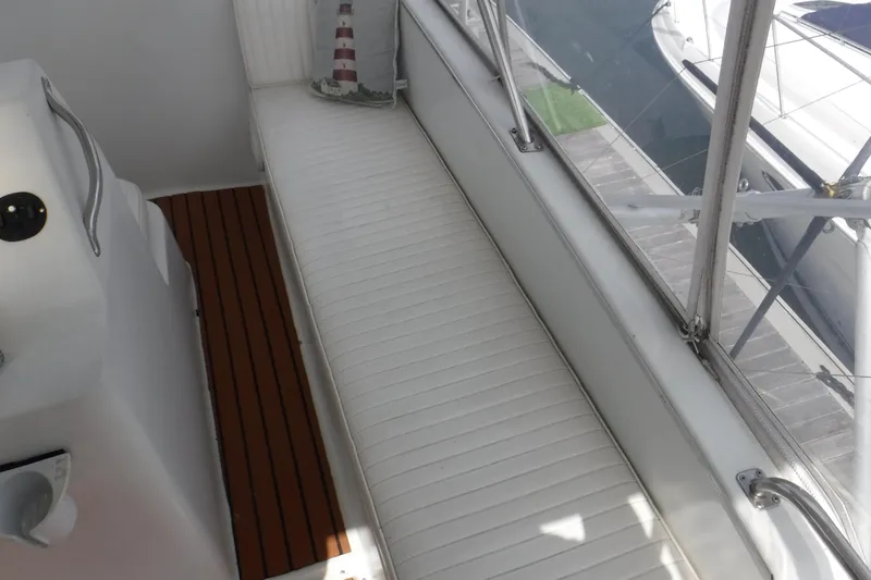  Yacht Photos Pics 1989 Ocean Yachts 44 Super Sport Custom interior with white seating and wooden flooring.
