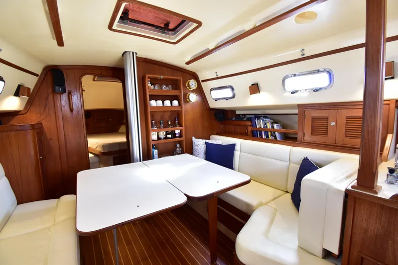 Promises Yacht Photos Pics Interior of 1998 Island Packet 350 sailboat with cozy seating and wooden cabinetry.