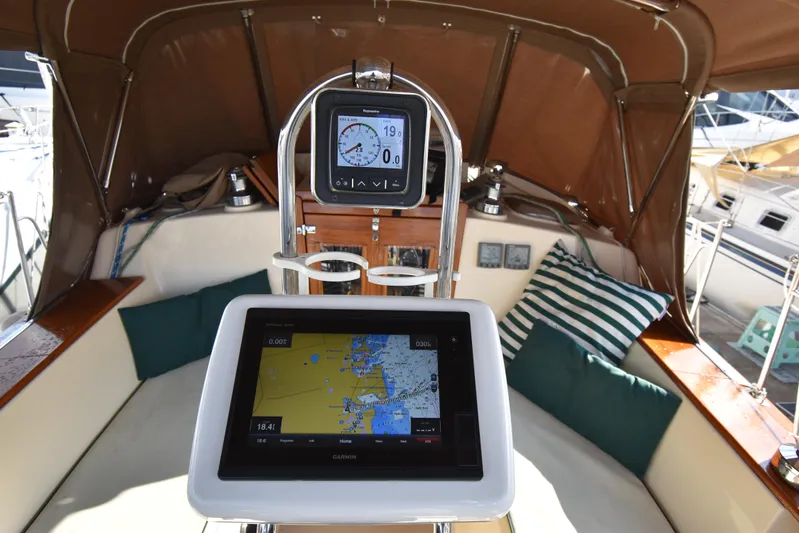 Promises Yacht Photos Pics Cockpit of 1998 Island Packet 350 sailboat with navigation equipment and cushions.