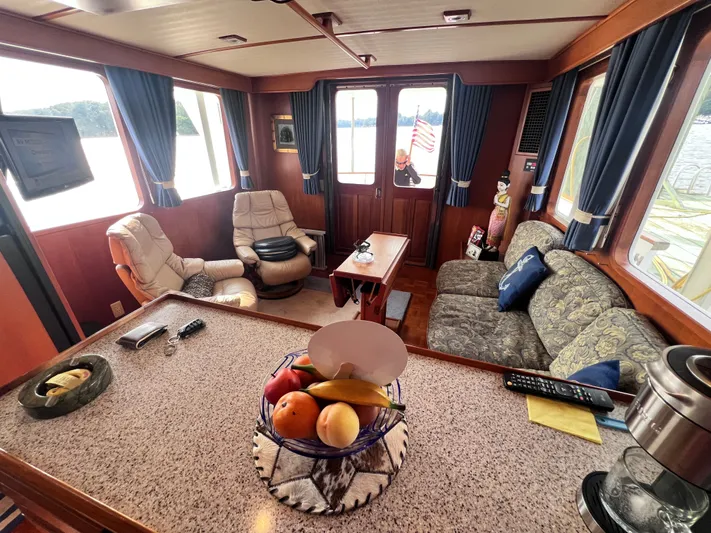 Xanadu Yacht Photos Pics Luxurious 2006 DeFever Pilothouse interior with plush seating, fruit basket, and scenic views.