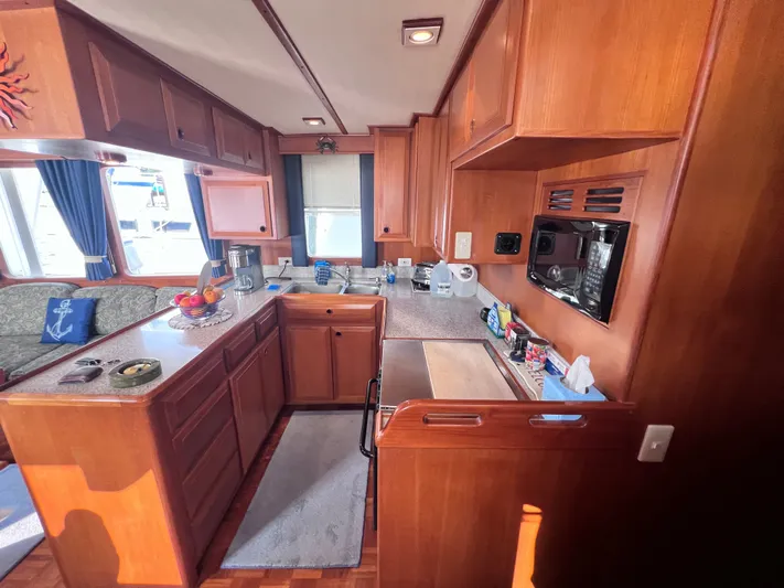Xanadu Yacht Photos Pics 2006 DeFever Pilothouse kitchen with wooden cabinetry, countertop, and appliances.