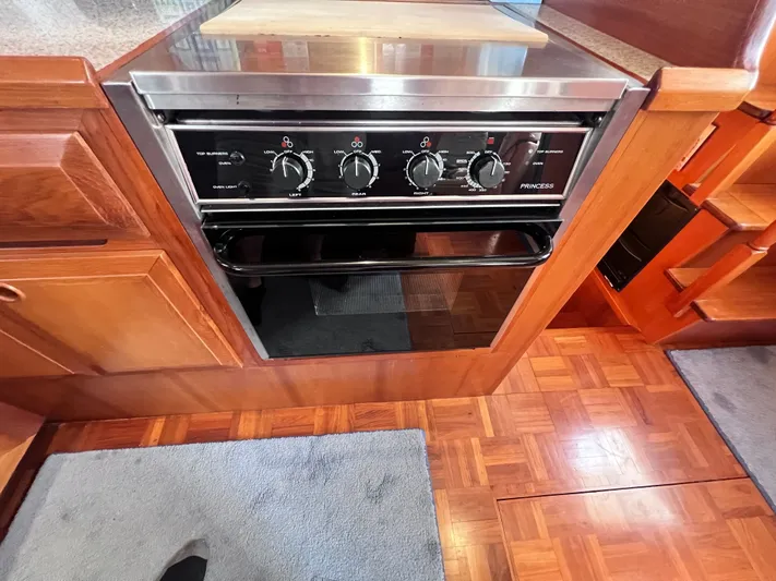 Xanadu Yacht Photos Pics 2006 DeFever Pilothouse kitchen with a built-in Princess oven and wooden cabinetry.