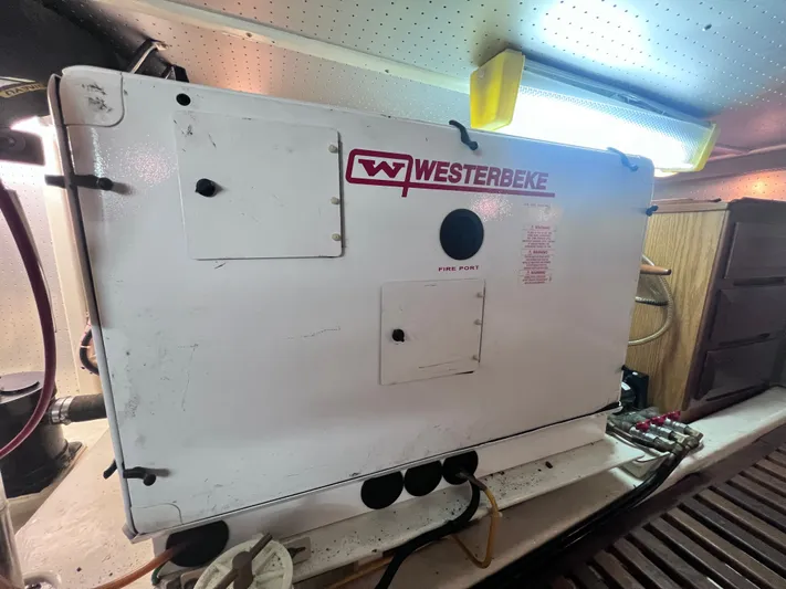 Xanadu Yacht Photos Pics Westerbeke generator in 2006 DeFever Pilothouse engine room, illuminated by overhead light.