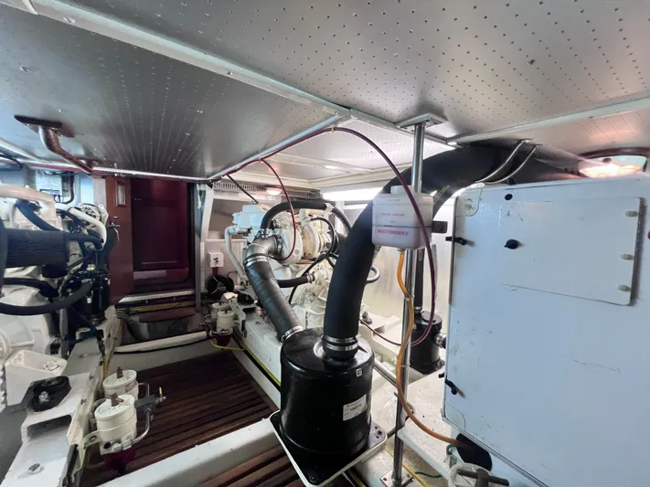 Xanadu Yacht Photos Pics Engine room of a 2006 DeFever Pilothouse yacht, showcasing mechanical components and piping.