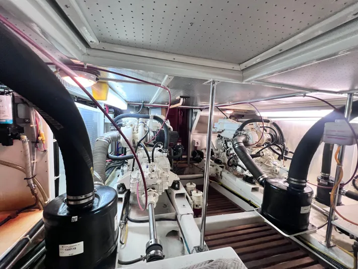 Xanadu Yacht Photos Pics Engine room of a 2006 DeFever Pilothouse yacht, showcasing mechanical components and systems.