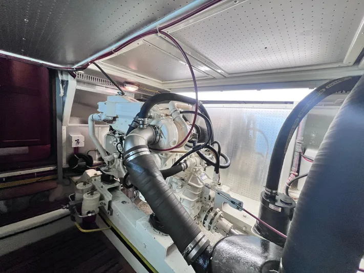 Xanadu Yacht Photos Pics Engine room of 2006 DeFever Pilothouse yacht, showcasing mechanical components and piping.