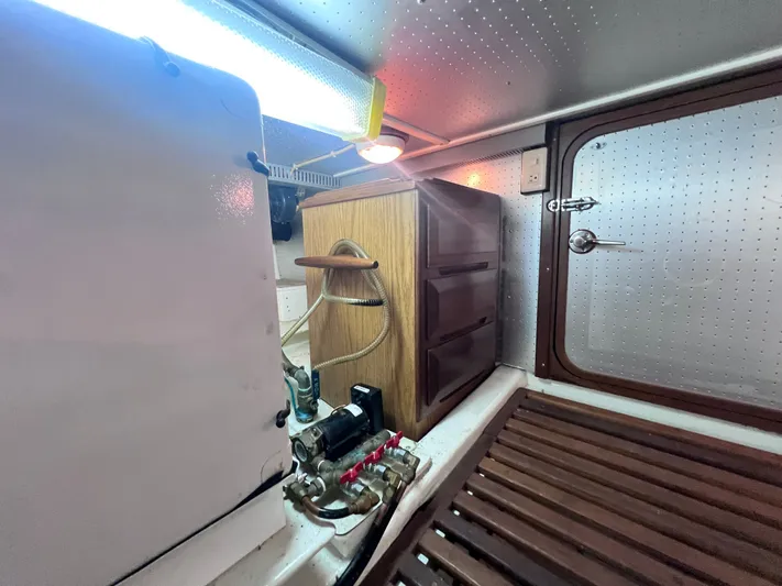 Xanadu Yacht Photos Pics 2006 DeFever Pilothouse interior with wooden cabinetry and mechanical components.