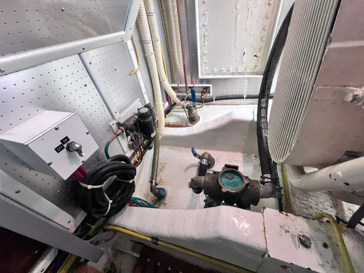 Xanadu Yacht Photos Pics Engine room of 2006 DeFever Pilothouse with pipes, valves, and control panel.