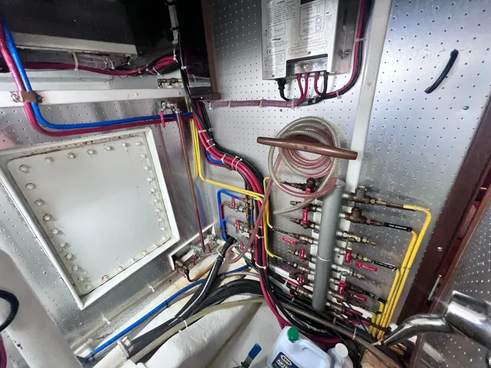 Xanadu Yacht Photos Pics Engine room of 2006 DeFever Pilothouse with complex piping and wiring system.