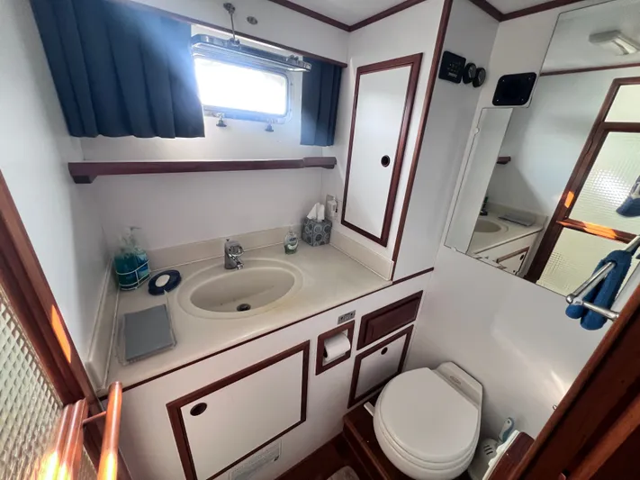 Xanadu Yacht Photos Pics Bathroom interior of 2006 DeFever Pilothouse yacht, featuring sink and toilet.