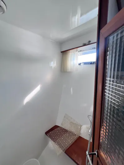 Xanadu Yacht Photos Pics 2006 DeFever Pilothouse interior with wooden accents and small window.