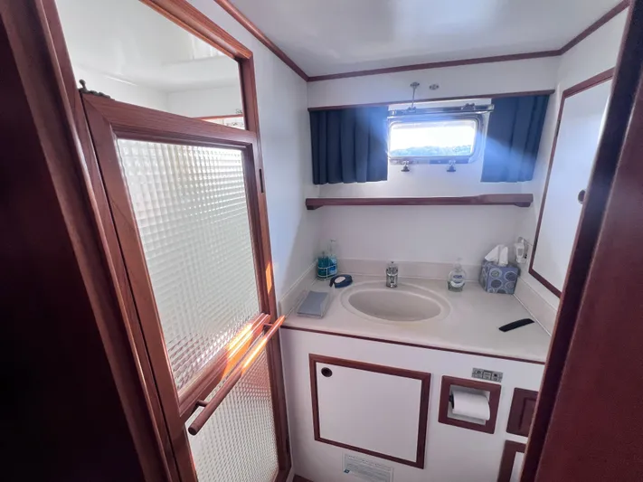 Xanadu Yacht Photos Pics 2006 DeFever Pilothouse bathroom with sink, window, and wooden accents.