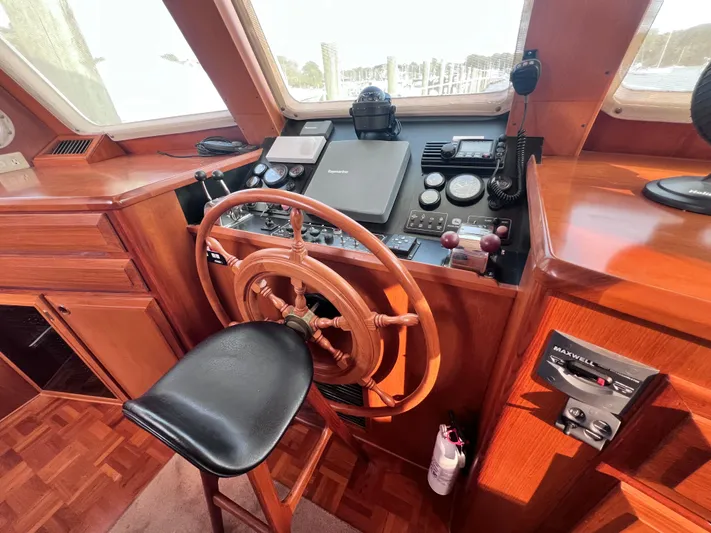 Xanadu Yacht Photos Pics 2006 DeFever Pilothouse helm with wooden wheel and navigation equipment.