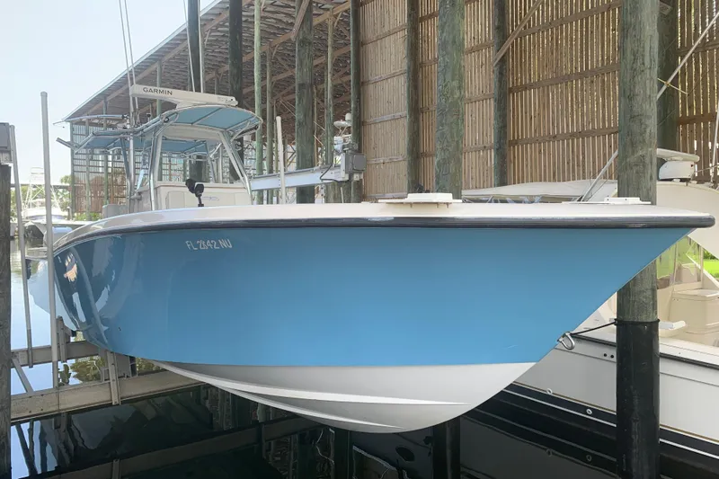  Yacht Photos Pics 2008 Invincible 36 CC boat in dry dock, featuring a sleek blue hull.