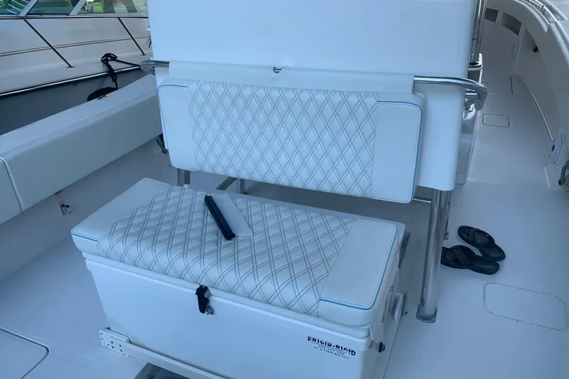  Yacht Photos Pics Invincible 36 CC 2008 boat interior with cushioned seating and cooler.