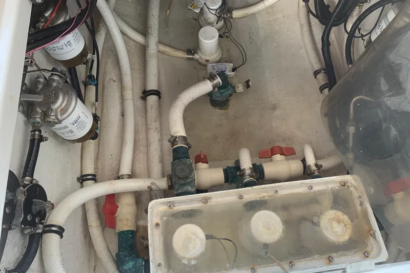  Yacht Photos Pics Engine compartment of a 2008 Invincible 36 CC boat, showcasing pipes and filters.