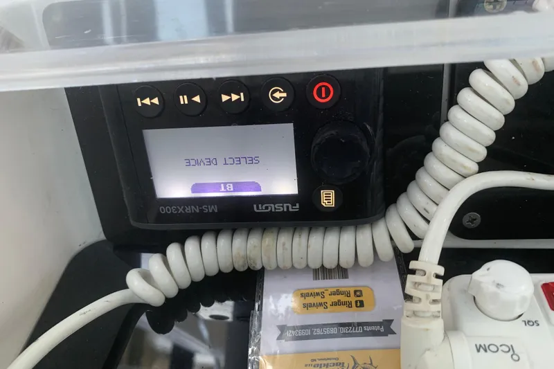  Yacht Photos Pics Control panel of a 2008 Invincible 36 CC boat with coiled cables and display.