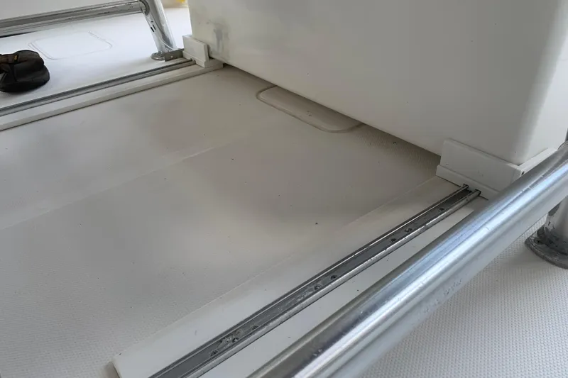  Yacht Photos Pics Interior view of 2008 Invincible 36 CC boat, featuring metal railings and white flooring.