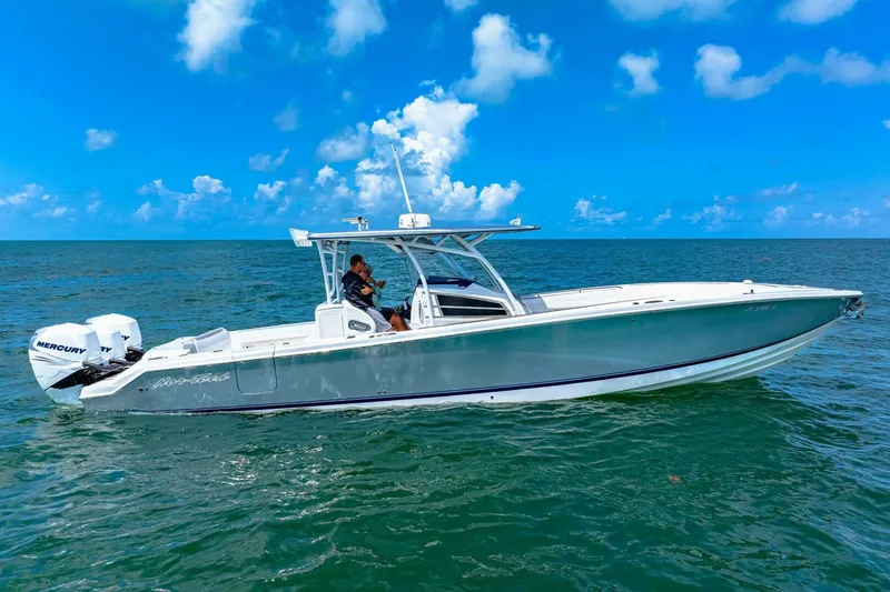  Yacht Photos Pics 2021 Nor-Tech 390 SS boat cruising on open water under a clear blue sky.