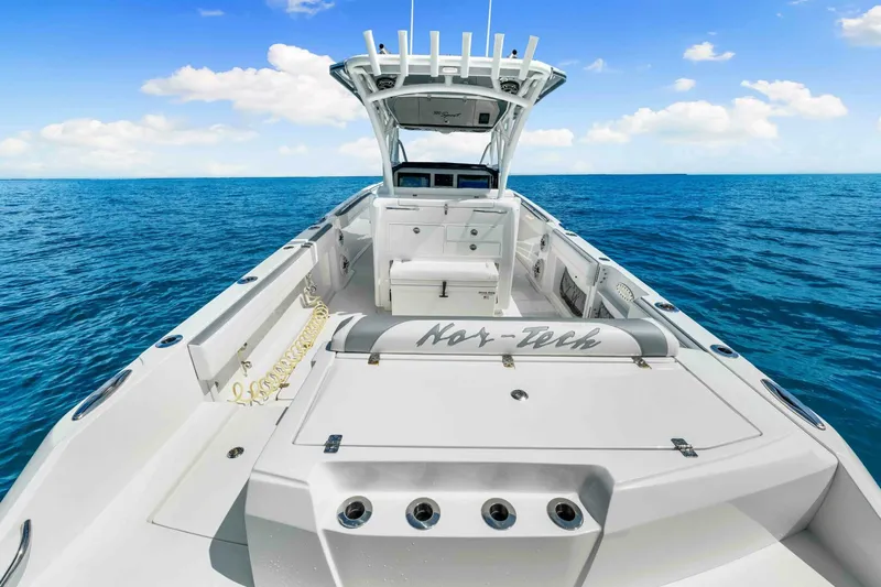  Yacht Photos Pics 2021 Nor-Tech 390 SS boat on open ocean, clear sky, luxury design.