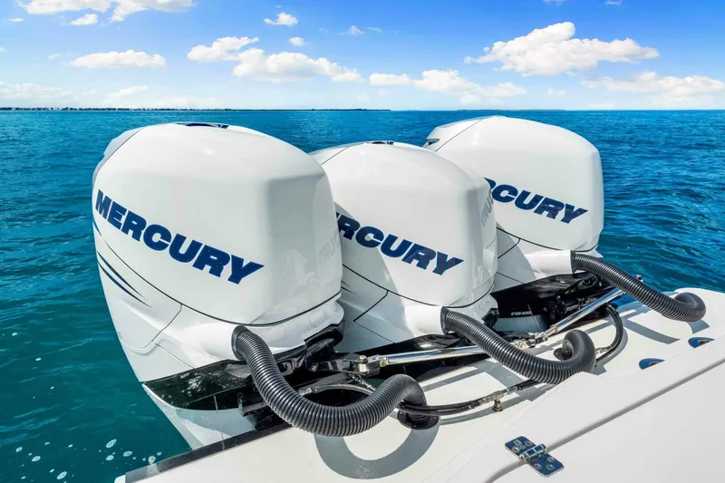  Yacht Photos Pics Triple Mercury outboard engines on a 2021 Nor-Tech 390 SS boat in clear blue waters.