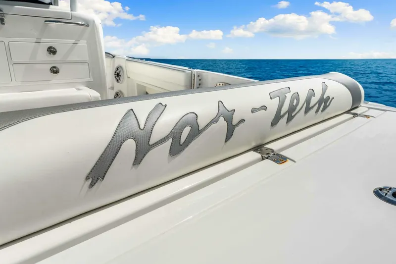  Yacht Photos Pics 2021 Nor-Tech 390 SS boat interior with logo, ocean view, and clear sky.