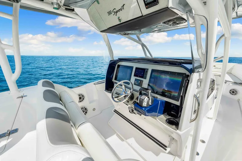  Yacht Photos Pics 2021 Nor-Tech 390 SS boat cockpit with modern navigation system, steering wheel, and ocean view.