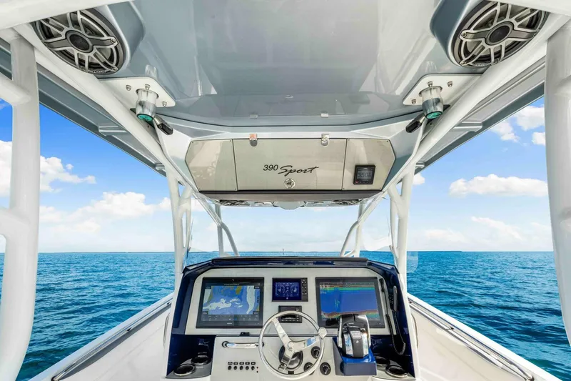  Yacht Photos Pics Cockpit view of 2021 Nor-Tech 390 SS boat with navigation screens, on open sea.
