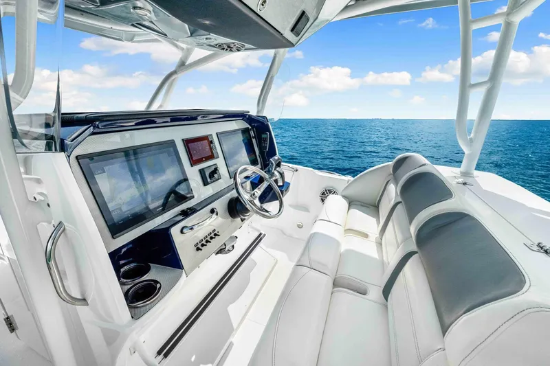  Yacht Photos Pics 2021 Nor-Tech 390 SS boat interior with modern dashboard and ocean view.