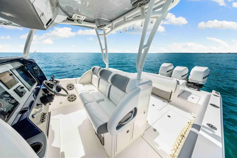  Yacht Photos Pics 2021 Nor-Tech 390 SS boat interior with ocean view, featuring helm and seating area.