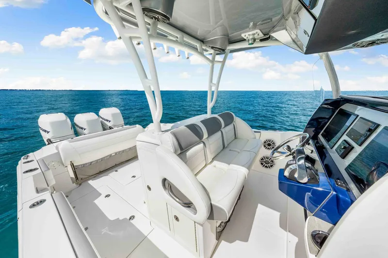  Yacht Photos Pics 2021 Nor-Tech 390 SS boat interior with luxurious seating and advanced controls on open water.
