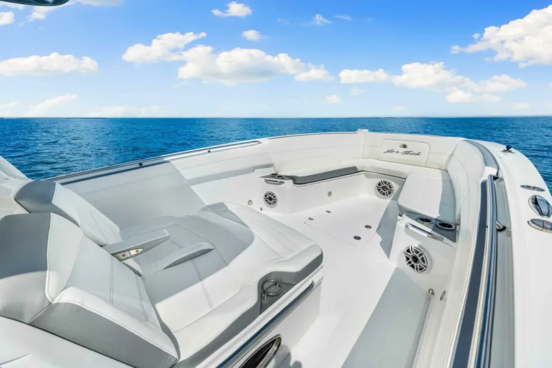  Yacht Photos Pics 2021 Nor-Tech 390 SS boat interior with luxurious seating, ocean view, and clear blue sky.