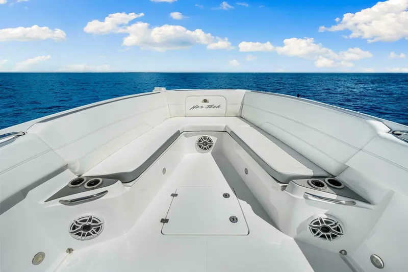  Yacht Photos Pics 2021 Nor-Tech 390 SS boat interior with white seating, ocean view, and blue sky.