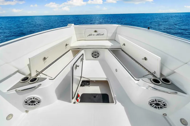  Yacht Photos Pics 2021 Nor-Tech 390 SS boat interior with open storage, cup holders, and ocean view.