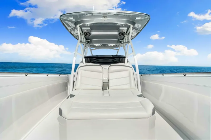  Yacht Photos Pics 2021 Nor-Tech 390 SS boat with sleek seating, ocean backdrop, and clear blue sky.