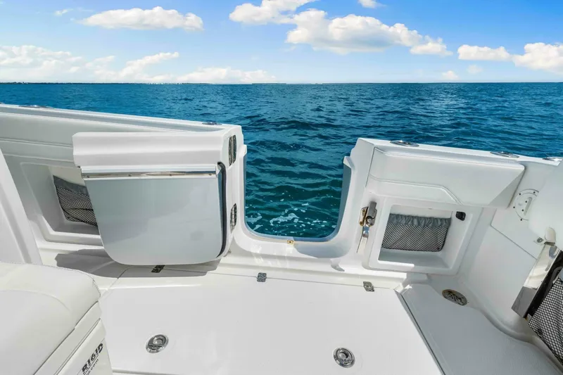  Yacht Photos Pics 2021 Nor-Tech 390 SS boat deck with ocean view and open storage compartments.