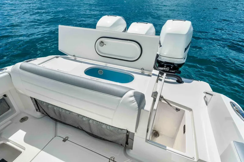  Yacht Photos Pics 2021 Nor-Tech 390 SS boat with triple engines, white seating, and storage compartments on blue water.