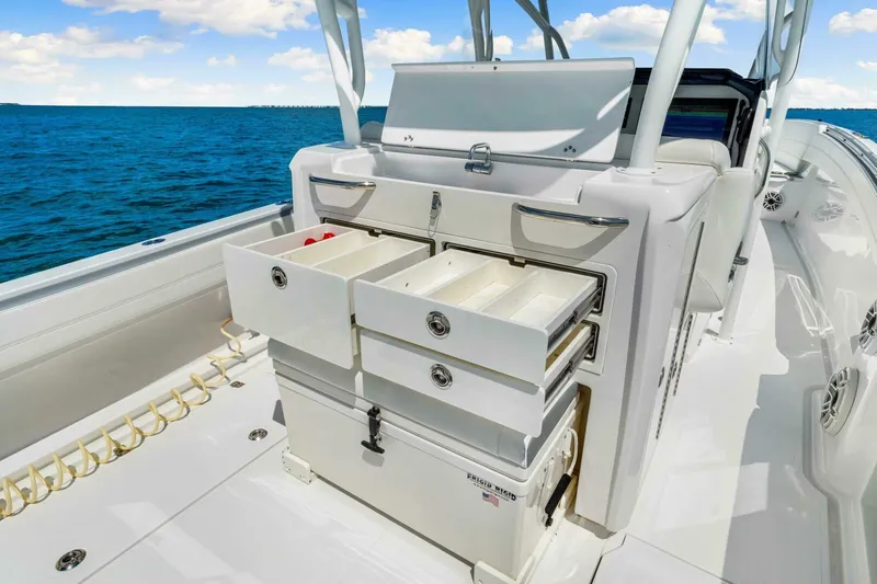  Yacht Photos Pics 2021 Nor-Tech 390 SS boat with open storage drawers on deck, ocean in background.
