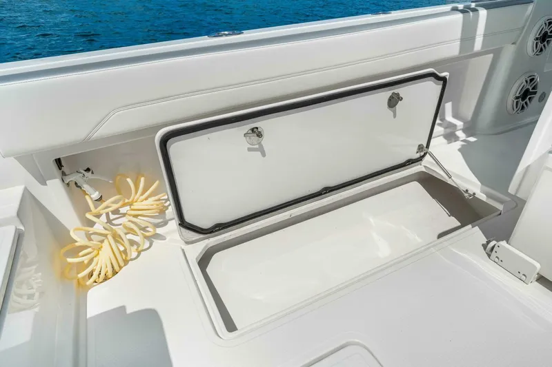  Yacht Photos Pics Open storage compartment on 2021 Nor-Tech 390 SS boat, with coiled hose inside.